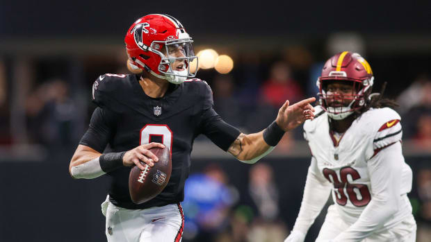 Oct 15, 2023; Atlanta, Georgia, USA; Atlanta Falcons quarterback Desmond Ridder (9) scrambles past Washington Commanders defensive end James Smith-Williams (96) in the first quarter at Mercedes-Benz Stadium.